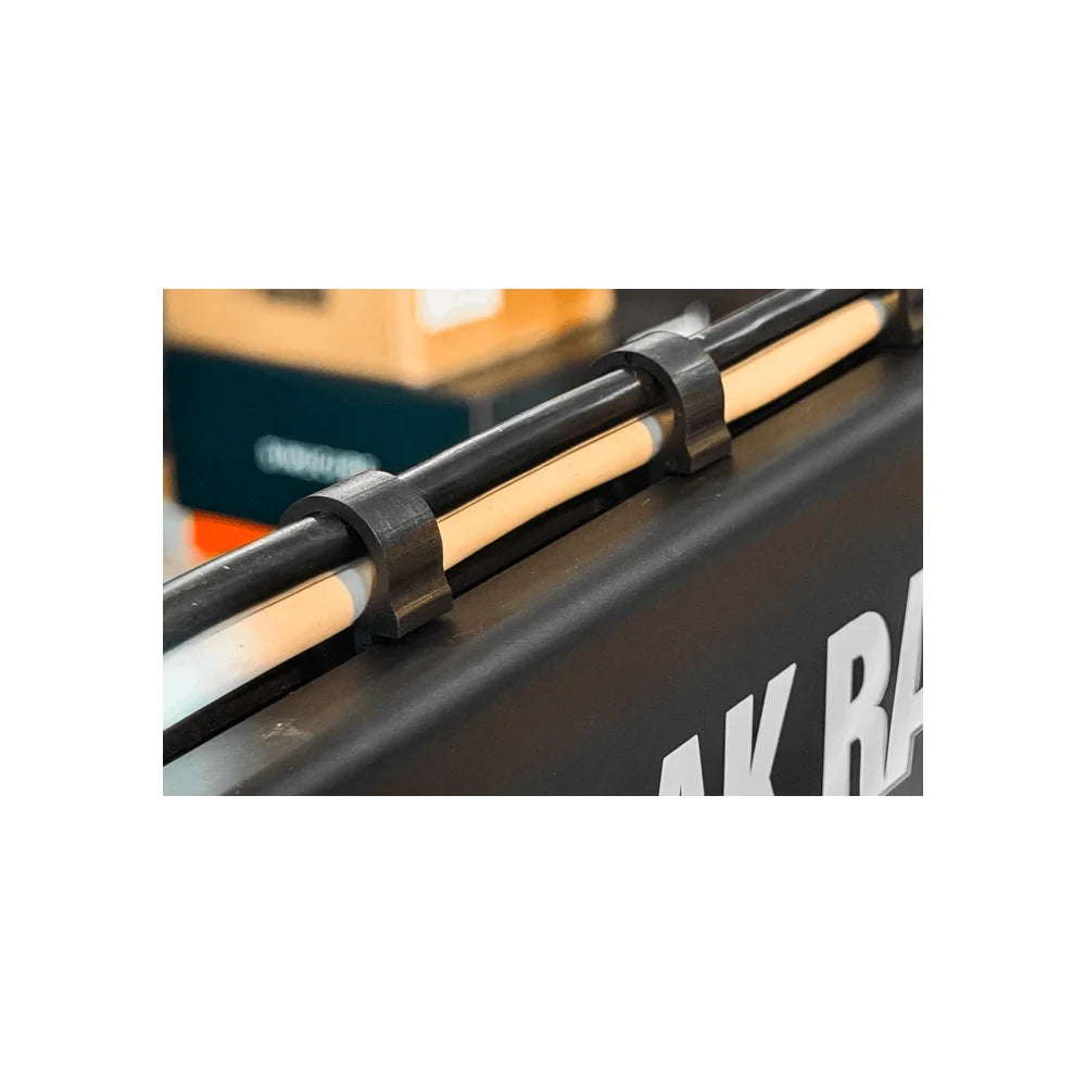 Trak Racer cable management clips in use, securing cables along a T-slot rig rail