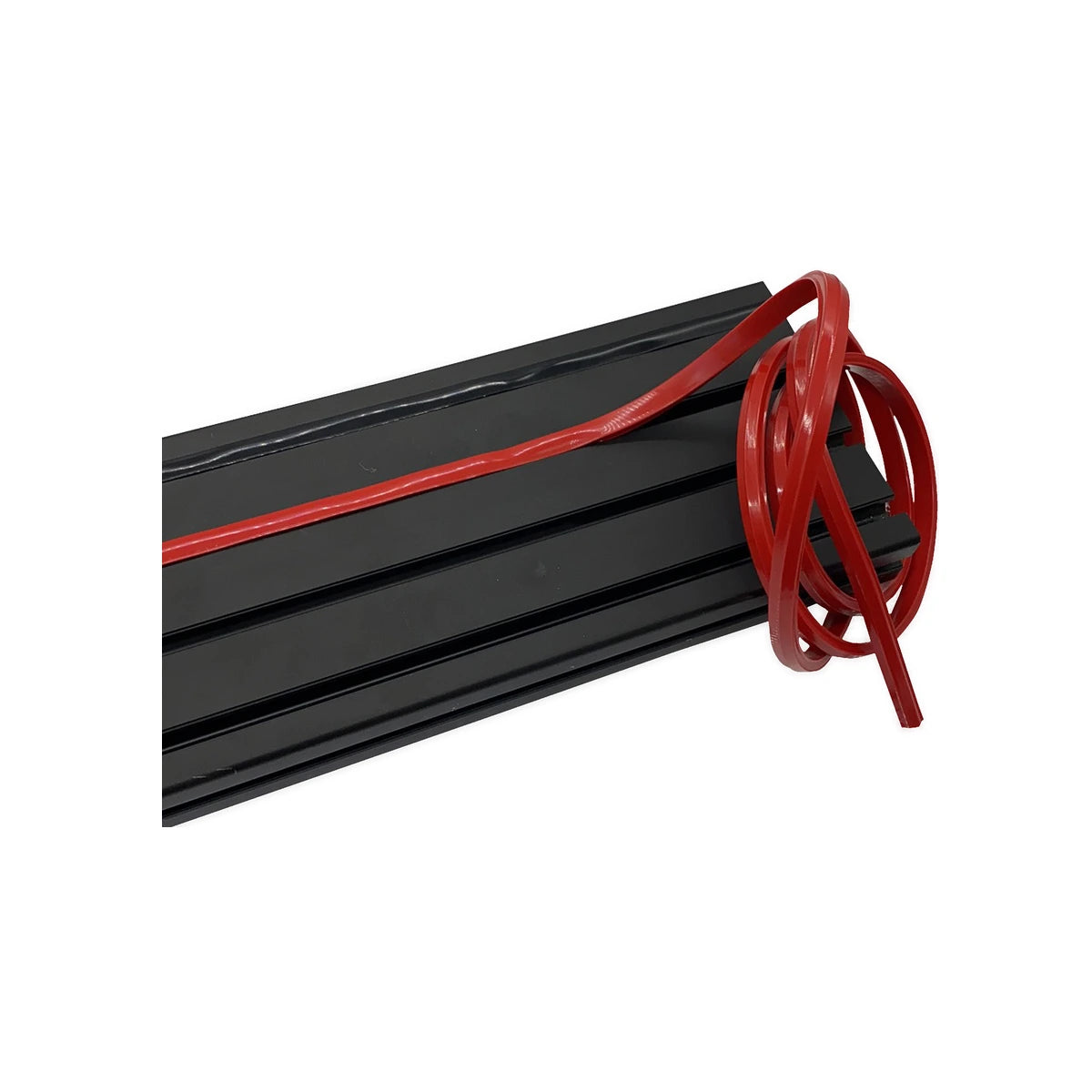 Trak Racer rubber dust strip, red, close-up being inserted into an aluminium profile T-slot