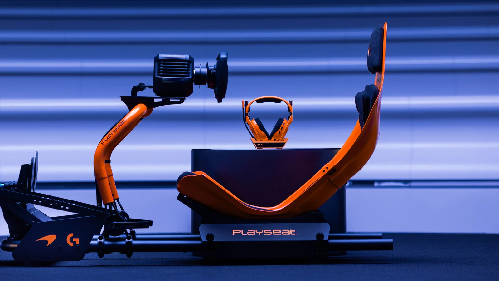 Playseat Formula Instinct McLaren Racing Edition fitted with a Logitech G direct drive wheel (sold separately), blue studio backdrop