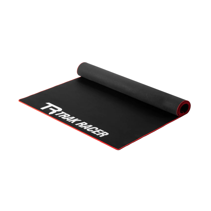 Trak Racer Premium Neoprene Sim Rig Floor Mat, black mat partly rolled with red trim edge and white Trak Racer logo