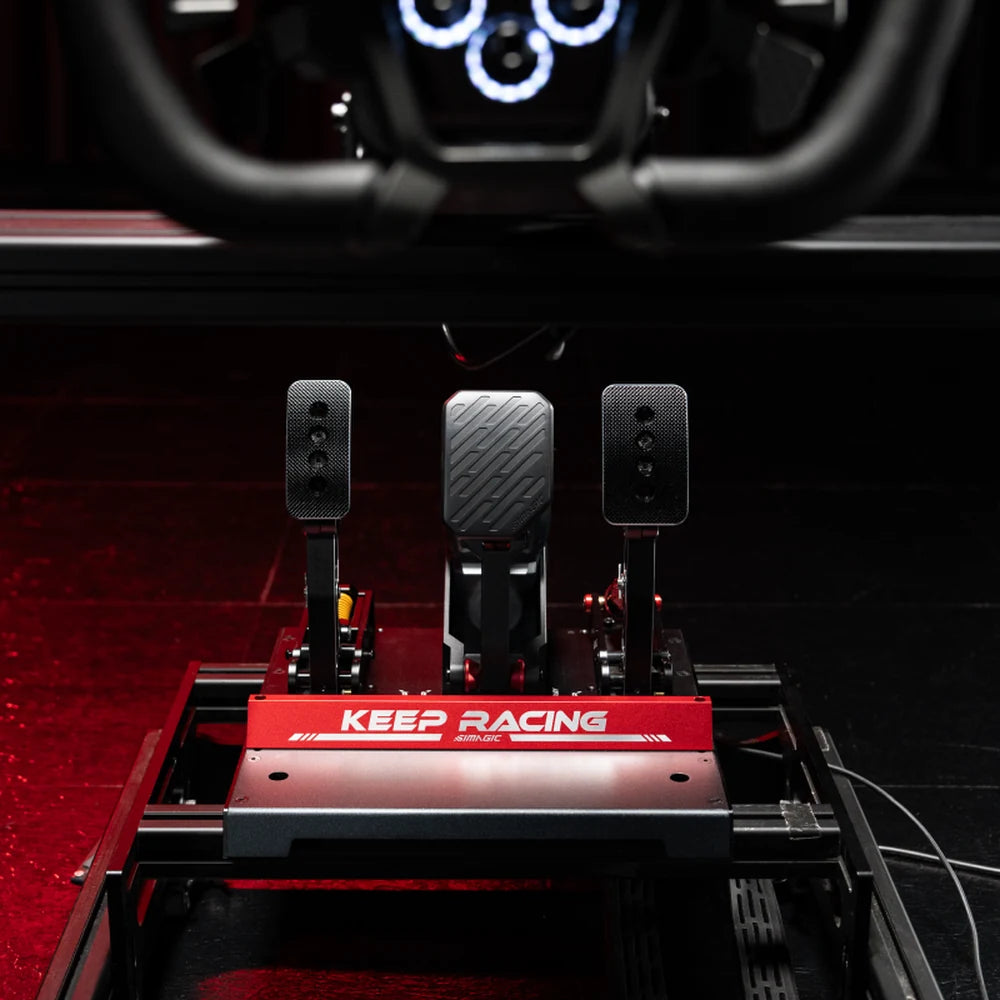 Simagic P-Active active brake in the centre of a three-pedal Simagic setup on a red Keep Racing baseplate